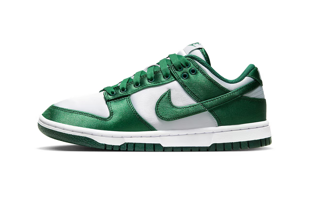 Satin uppers are added to the "Michigan State" version of the Nike Dunk Low.